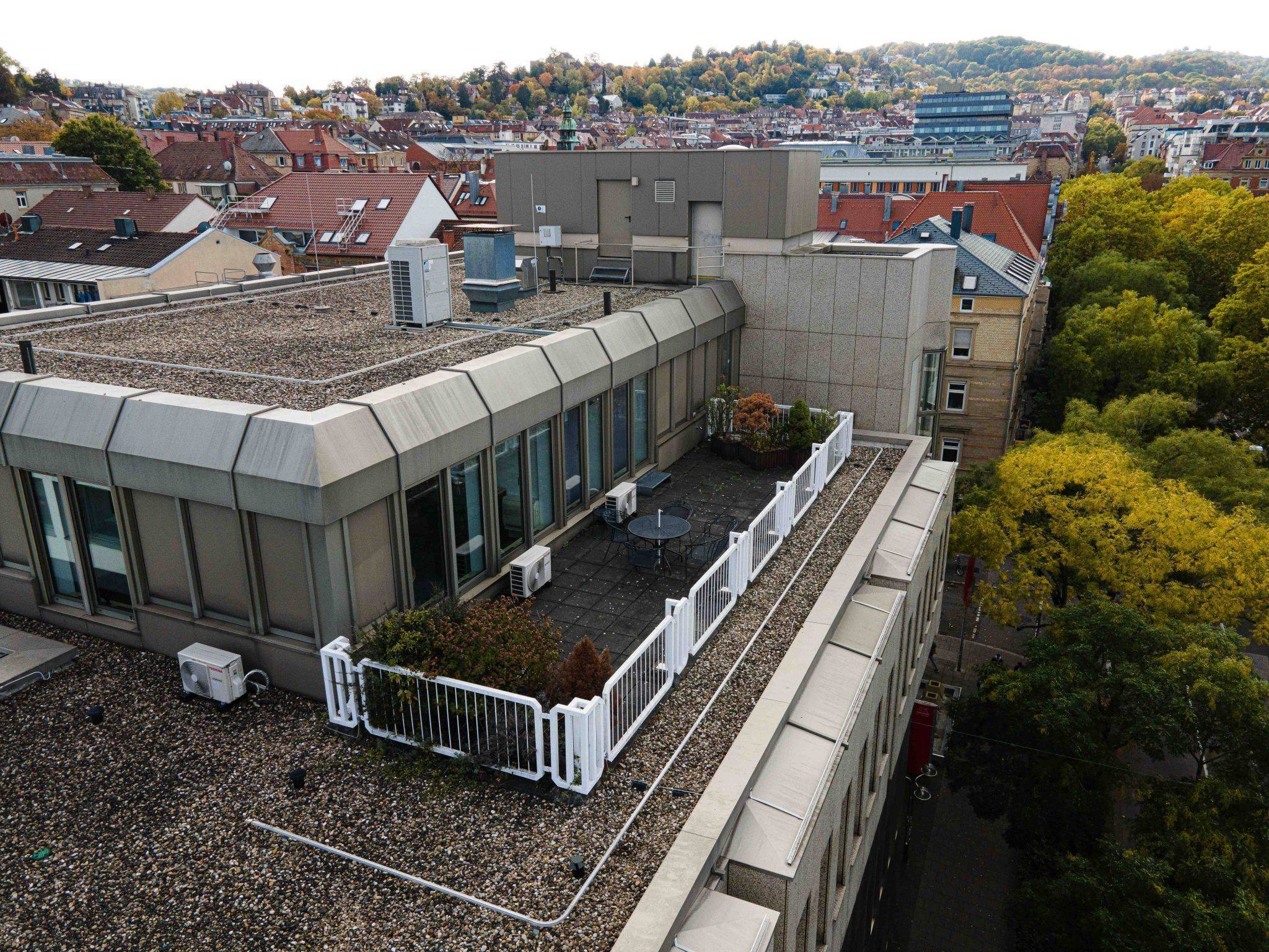 Eine Immobilienfotografie, die den atemberaubenden Blick auf eine Stadt von der Spitze eines Gebäudes aus einfängt.